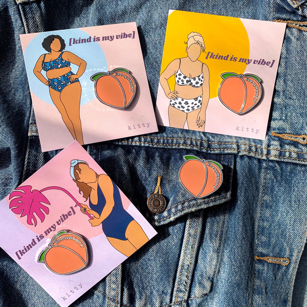 Peach shaped accessory pin with EveryBOOTY written on it